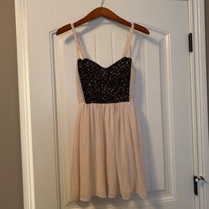 Cream spaghetti strap dress with black detailing.